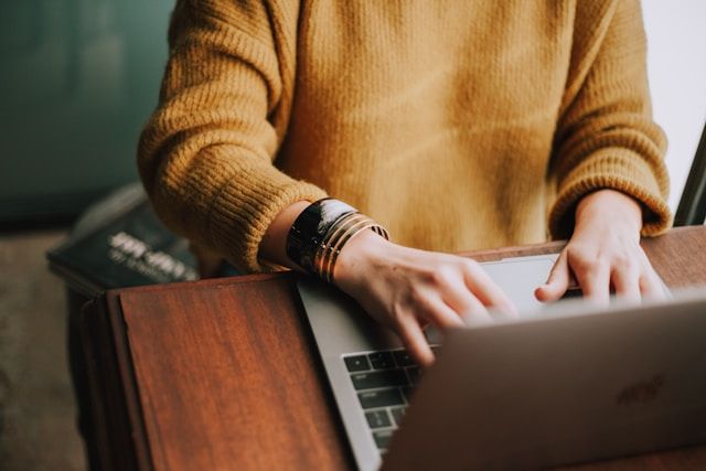 Image of a person typing on a laptop