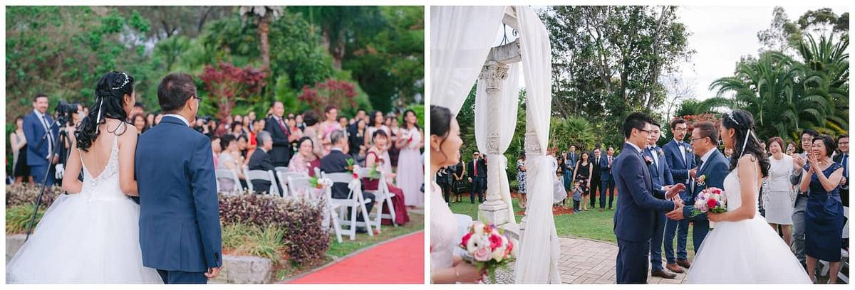 Bride’s first steps into the ceremony, guests turning to admire her at Oatlands House
